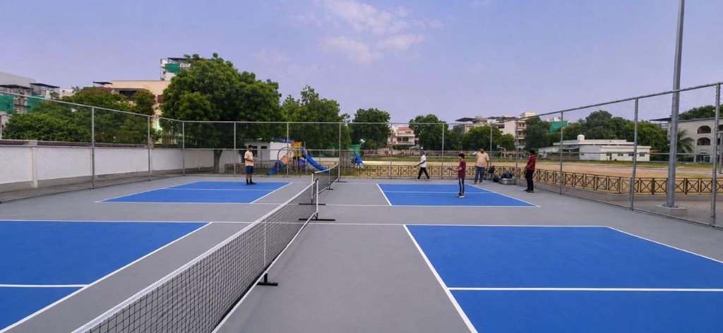 Players on outdoor pickleball courts at The Social Court Gurugram